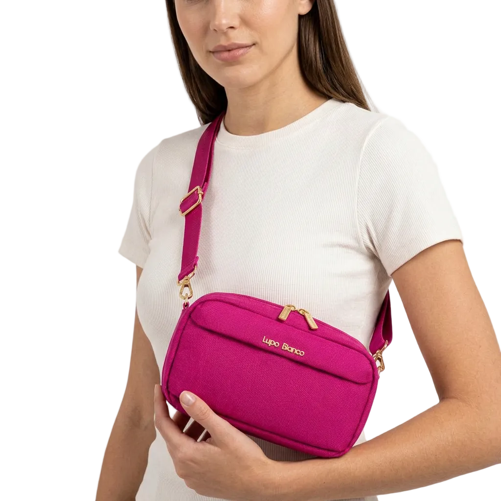Woman holding a pink crossbody bag with 'Lupo Bianco' branding on a white background