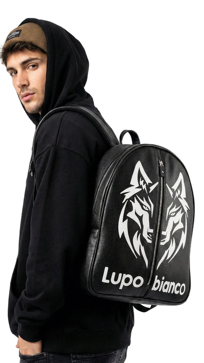 Person wearing a black hoodie with a black backpack featuring white wolf designs and 'Lupo bianco' text.